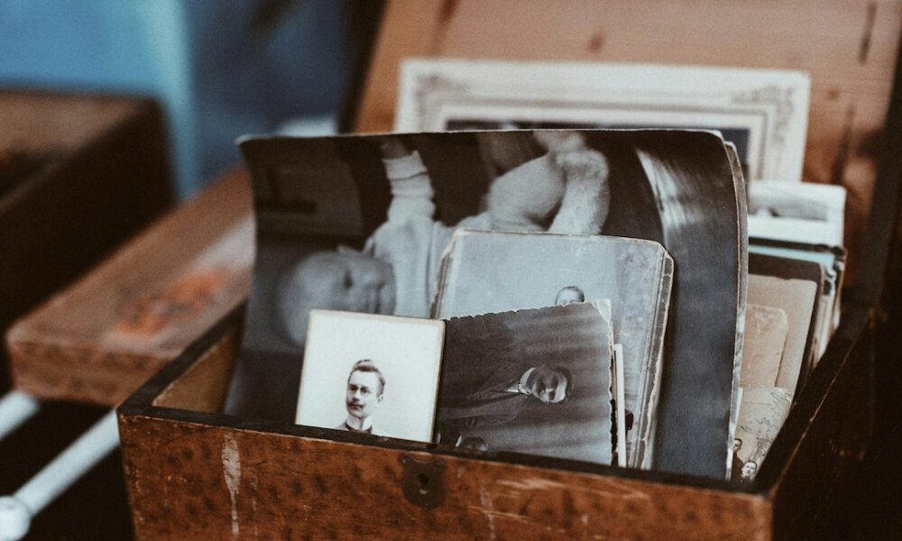 A box of old vintage black and white photographs.
