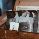 A box of old vintage black and white photographs.
