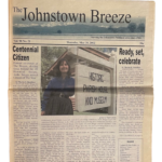 A photo of the front page of The Johnstown Breeze newspaper from May 30, 2002 featuring Ardis Briggs-Tomlinson as Centennial Citizen with a photo of her standing in front the Historic Parish House and Museum.